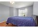This bedroom has wood-look floors and a window with curtains at 2417 Fairway Oaks Dr # 22, Palmetto, FL 34221