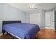 This bedroom has wood-look floors, a ceiling fan, and a double closet at 2417 Fairway Oaks Dr # 22, Palmetto, FL 34221