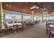 Bright dining room with multiple tables, chairs, large windows, and neutral décor at 2417 Fairway Oaks Dr # 22, Palmetto, FL 34221