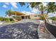 Exterior building with a covered entrance, landscaped front, and paved driveway at 2417 Fairway Oaks Dr # 22, Palmetto, FL 34221