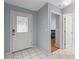 Foyer with white tile flooring, light blue walls, and a view of the main bedroom at 2417 Fairway Oaks Dr # 22, Palmetto, FL 34221