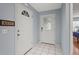 Bright foyer with white tile flooring, light blue walls, and decorative front door at 2417 Fairway Oaks Dr # 22, Palmetto, FL 34221