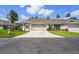 Charming single-story home with a large driveway, two-car garage and tropical landscaping at 2417 Fairway Oaks Dr # 22, Palmetto, FL 34221