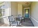 Inviting front porch featuring comfortable seating, a stylish rug, and a decorative front door at 2417 Fairway Oaks Dr # 22, Palmetto, FL 34221
