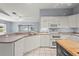 Bright kitchen featuring white appliances and cabinets with an island cooktop, seamlessly connects to living spaces at 2417 Fairway Oaks Dr # 22, Palmetto, FL 34221