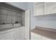 Bright laundry room features a washer, dryer, and shelving for convenient organization and storage at 2417 Fairway Oaks Dr # 22, Palmetto, FL 34221