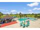 Community pool and bar area with ample seating overlooking the golf course on a sunny day at 2417 Fairway Oaks Dr # 22, Palmetto, FL 34221