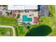 Aerial view of a luxurious swimming pool with surrounding landscaping and a nearby golf course at 2417 Fairway Oaks Dr # 22, Palmetto, FL 34221