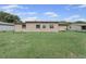 Exterior view of backyard with green grass, and home's siding at 268 Alsace Ave, Venice, FL 34293