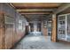 Interior view of a space with paneled walls, bare ceiling, and concrete floors, needing renovation at 268 Alsace Ave, Venice, FL 34293