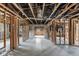 Interior shot of a gutted home with exposed wooden framing and concrete floors, ready for renovation at 268 Alsace Ave, Venice, FL 34293