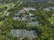 A high-angle shot of the tennis courts, pool and pickleball courts shows many amenities at 3003 Quail Holw # 10, Sarasota, FL 34235