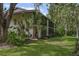 The backyard is spacious with well-maintained grass and lush landscaping at 3003 Quail Holw # 10, Sarasota, FL 34235