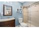 Bright bathroom featuring a vanity, toilet, decorative shelves, and glass shower at 3003 Quail Holw # 10, Sarasota, FL 34235