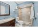 Well-lit bathroom featuring a vanity, toilet, decorative shelves, and glass shower at 3003 Quail Holw # 10, Sarasota, FL 34235