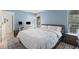 Comfortable bedroom with a white bed, natural light and a desk space at 3003 Quail Holw # 10, Sarasota, FL 34235