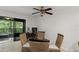 Cozy dining area with a glass table, wicker chairs, and access to the lanai at 3003 Quail Holw # 10, Sarasota, FL 34235