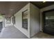 Inviting entryway featuring a black door, tile flooring, and a window, creating a warm welcome at 3003 Quail Holw # 10, Sarasota, FL 34235