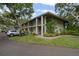 Two-story condo building featuring balconies and landscaping, set in a lush green environment at 3003 Quail Holw # 10, Sarasota, FL 34235