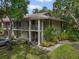 Two-story condo building featuring balconies and landscaping, set in a lush green environment at 3003 Quail Holw # 10, Sarasota, FL 34235