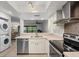 Well-lit kitchen features stainless steel appliances, including a dishwasher and oven, along with neutral countertops at 3003 Quail Holw # 10, Sarasota, FL 34235