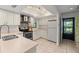 Bright kitchen with stainless steel appliances, light-colored cabinetry, and tile flooring at 3003 Quail Holw # 10, Sarasota, FL 34235