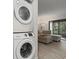 Convenient laundry area with stacked washer/dryer and comfortable living space at 3003 Quail Holw # 10, Sarasota, FL 34235