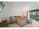 Comfortable living room with a large sectional sofa and access to a screened lanai at 3003 Quail Holw # 10, Sarasota, FL 34235