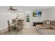 Open floor plan with kitchen, dining area, and living room with comfortable seating and access to a screened patio at 3003 Quail Holw # 10, Sarasota, FL 34235