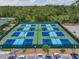 A birds-eye view of the blue and green community pickleball courts available to residents at 3003 Quail Holw # 10, Sarasota, FL 34235