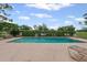 Community pool featuring lounge chairs surrounded by well-maintained landscaping at 3003 Quail Holw # 10, Sarasota, FL 34235