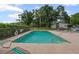 Community pool with lounge chairs and a surrounding fence for added safety and privacy at 3003 Quail Holw # 10, Sarasota, FL 34235