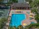 Aerial view of a pool surrounded by lounge chairs and greenery, creating a resort-like atmosphere at 3003 Quail Holw # 10, Sarasota, FL 34235