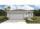 Charming single-story home featuring a two-car garage, stone accents, and well-manicured landscaping at 3222 Bitterroot Ln, Lakewood Ranch, FL 34211