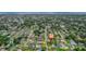 High aerial view showcases a charming neighborhood of single-Gathering homes with manicured lawns and mature trees near the ocean at 326 Randolph Rd, Venice, FL 34293