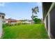 Expansive backyard featuring a lush lawn, mature trees, storage shed, and perimeter fence at 326 Randolph Rd, Venice, FL 34293