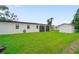 Spacious, green backyard with shed, partial fence, and screened patio overlooking the yard at 326 Randolph Rd, Venice, FL 34293