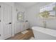Bright bathroom featuring a modern tub, vanity, and sleek fixtures at 326 Randolph Rd, Venice, FL 34293