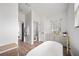 Modern bathroom featuring a soaking tub, vanity, and wood-look tile flooring at 326 Randolph Rd, Venice, FL 34293