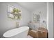 Bright bathroom with a soaking tub, vanity, and natural light from the window at 326 Randolph Rd, Venice, FL 34293