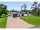 Beautifully landscaped home with a well-manicured lawn and a freshly painted exterior, showcasing its curb appeal at 326 Randolph Rd, Venice, FL 34293