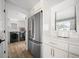 Bright kitchen with stainless steel refrigerator and a view into the laundry room at 326 Randolph Rd, Venice, FL 34293