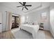 Comfortable main bedroom with wood floors, ceiling fan, and natural light from windows at 326 Randolph Rd, Venice, FL 34293