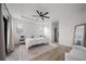 Bright bedroom featuring wood floors, a ceiling fan, and a sitting area at 326 Randolph Rd, Venice, FL 34293