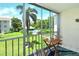 Balcony view of the swimming pool and beautifully landscaped grounds at 3985 Maceachen Blvd # 224, Sarasota, FL 34233