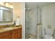 Bathroom with a sink and vanity, a toilet, and a glass shower at 3985 Maceachen Blvd # 224, Sarasota, FL 34233