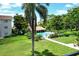 View of the community pool, deck, and landscaped lawn from the balcony at 3985 Maceachen Blvd # 224, Sarasota, FL 34233