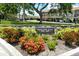 Tregate East community entrance sign with vibrant flowers and lush landscaping, offering a welcoming view at 3985 Maceachen Blvd # 224, Sarasota, FL 34233