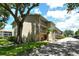 Exterior of a well-maintained two-story condo building with balconies and mature landscaping at 3985 Maceachen Blvd # 224, Sarasota, FL 34233