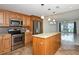 Updated kitchen featuring stainless steel appliances and a center island at 3985 Maceachen Blvd # 224, Sarasota, FL 34233